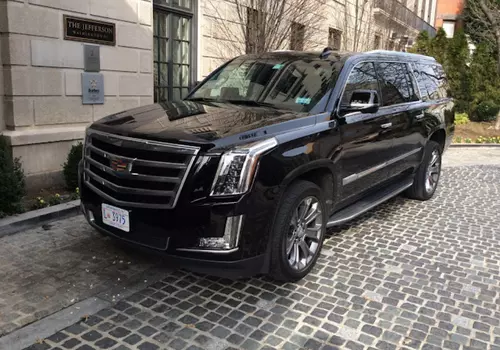 Black Cadillac Escalade SUV waiting client